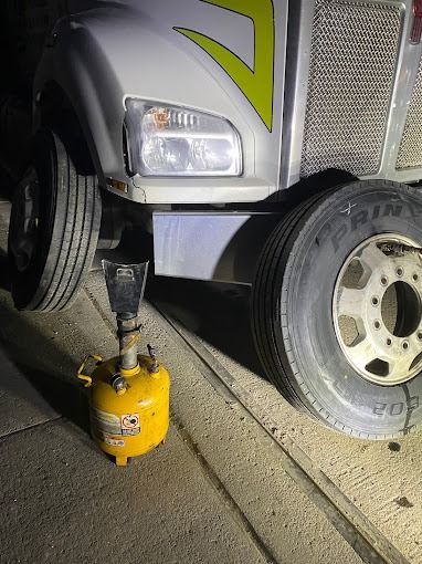 Truck tire being installed at night in the Bronx